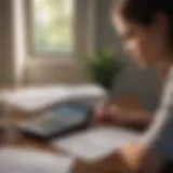 A young adult reviewing health insurance documents with a calculator.