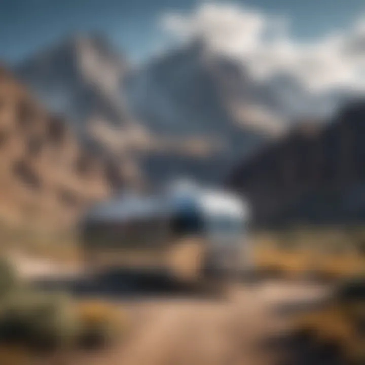 Airstream trailer parked in a scenic landscape with mountains in the background.